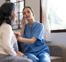 Aged care worker supporting an older client in a home care environment